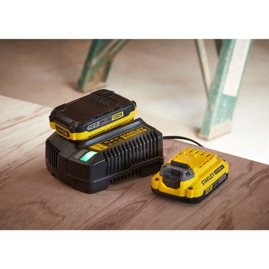 STANLEY FATMAX 20V battery charger with two STANLEY batteries 20V 2.0AH on a wood surface